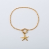 Zestaw srebrna pozłacana bransoletka i zawieszka w kształcie rozgwiazdy.