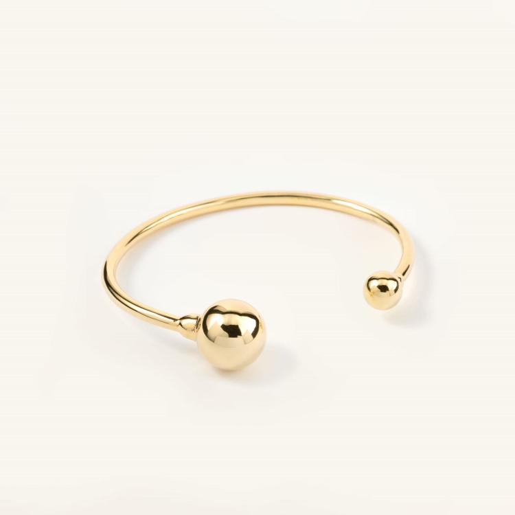 Bransoletka pozłacana sztywna zakończona dwoma kulami.