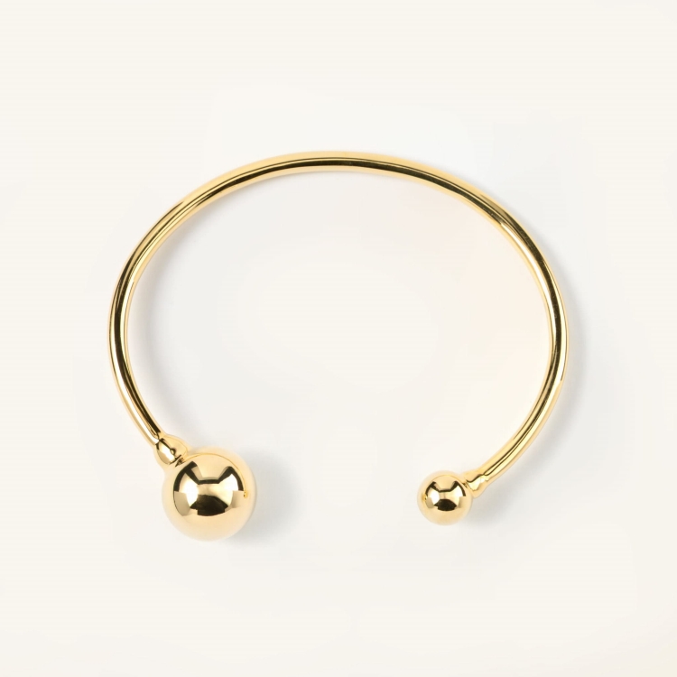 Bransoletka pozłacana sztywna zakończona dwoma kulami.