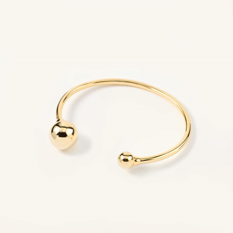Bransoletka pozłacana sztywna zakończona dwoma kulami.