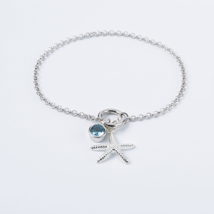 Zestaw srebrna bransoletka zawieszka z rozgwiazdą zawieszka z niebieskim oczkiem.